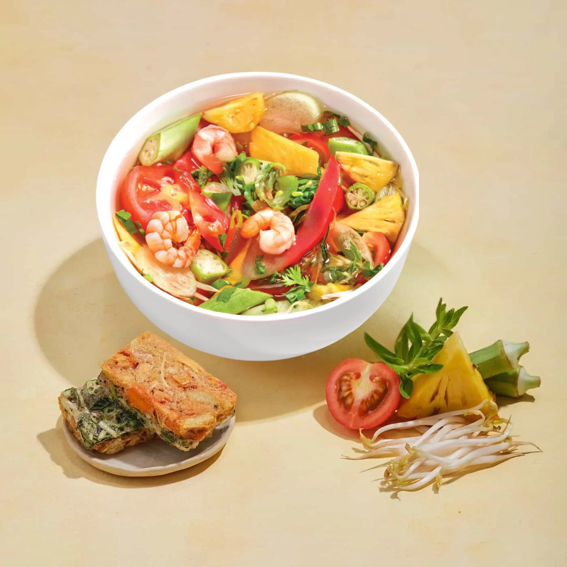 Vietnamese shrimp sweet and sour soup with tamarind broth and vegetables